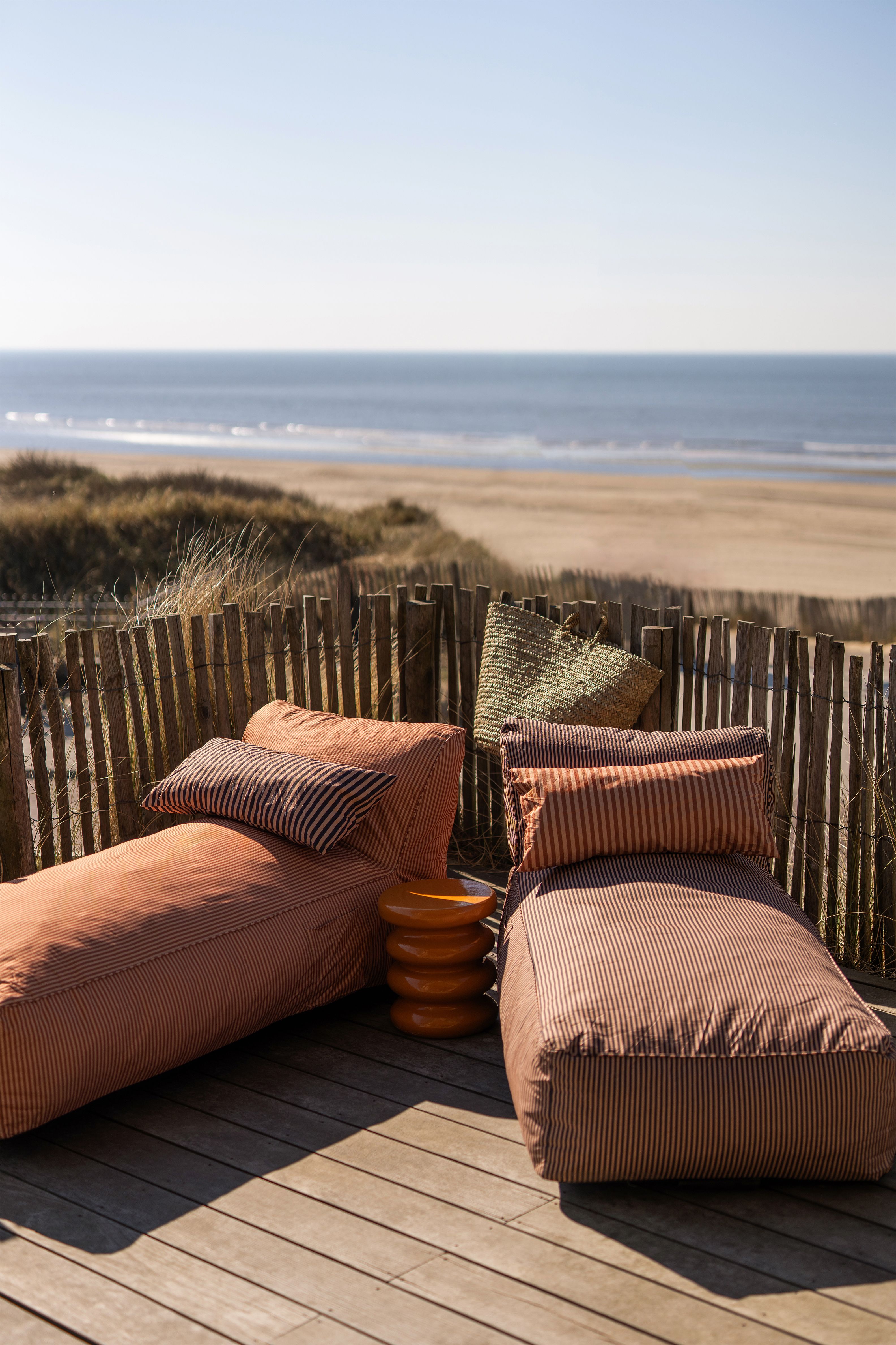 Gestreepte loungebedden die buiten bij het strand staan